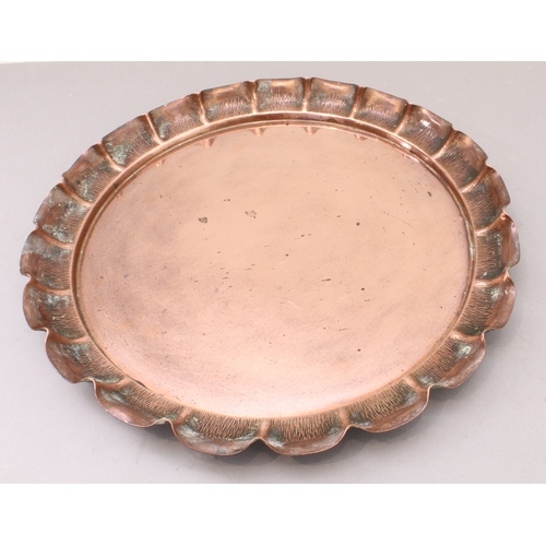 53 - Two pieces of copperware:
 1. an Arts & Crafts style and period hand-hammered circular copper dish, ... 