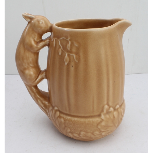 12 - Four ceramic jugs:
 an Art Deco Shelley example with reeded body and varying colours (34 cm high);
 ... 