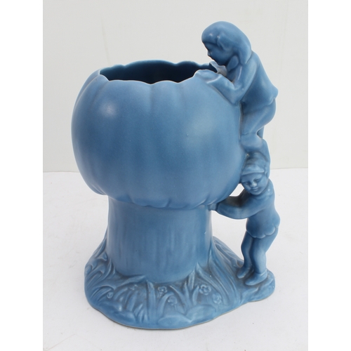 12 - Four ceramic jugs:
 an Art Deco Shelley example with reeded body and varying colours (34 cm high);
 ... 