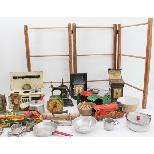 148 - An assortment of children's toys to include:
 two tinplate engines;
 a bell-pistol;
 kitchenware to ... 