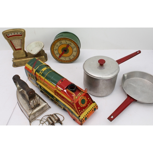 148 - An assortment of children's toys to include:
 two tinplate engines;
 a bell-pistol;
 kitchenware to ... 
