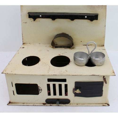 148 - An assortment of children's toys to include:
 two tinplate engines;
 a bell-pistol;
 kitchenware to ... 