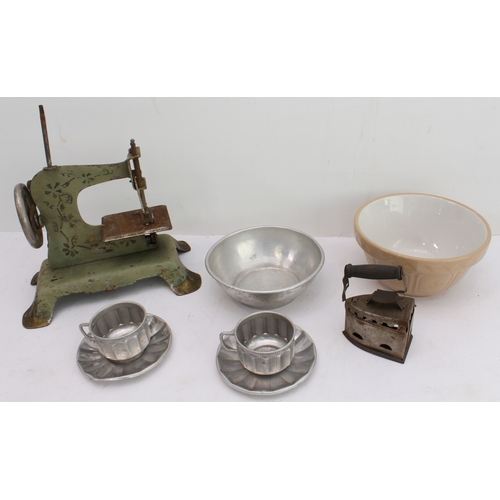 148 - An assortment of children's toys to include:
 two tinplate engines;
 a bell-pistol;
 kitchenware to ... 