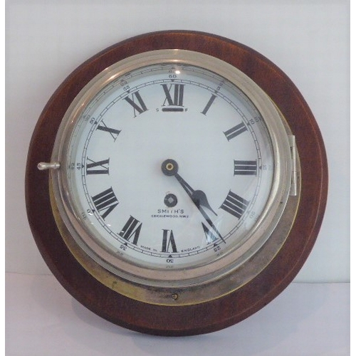 124 - An early 20th century eight-day ship's bulkhead clock (with modern replaced quartz movement) mounted... 