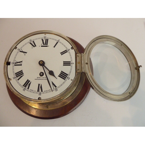 124 - An early 20th century eight-day ship's bulkhead clock (with modern replaced quartz movement) mounted... 