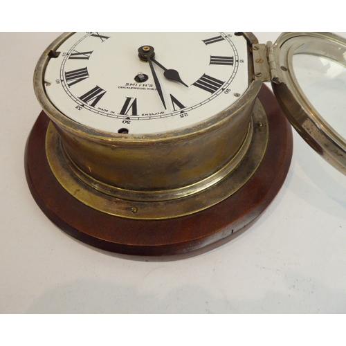 124 - An early 20th century eight-day ship's bulkhead clock (with modern replaced quartz movement) mounted... 