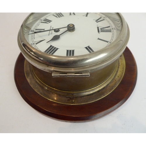 124 - An early 20th century eight-day ship's bulkhead clock (with modern replaced quartz movement) mounted... 