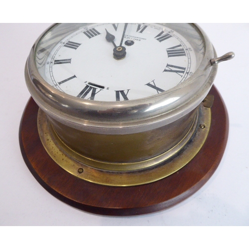 124 - An early 20th century eight-day ship's bulkhead clock (with modern replaced quartz movement) mounted... 