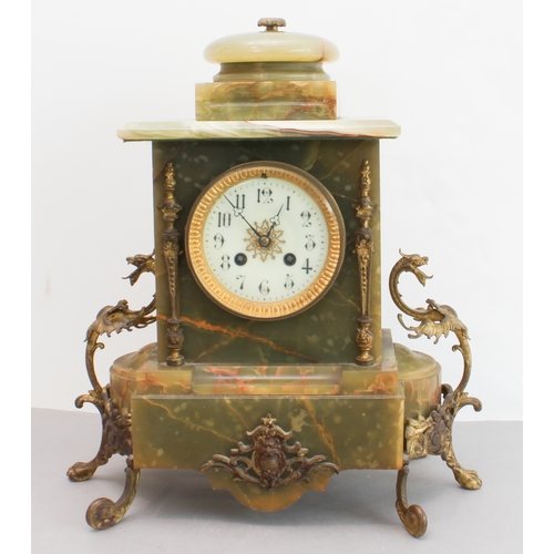 125 - A late 19th century gilt-metal-mounted and onyx-cased eight-day mantle clock: the white enamel dial ... 
