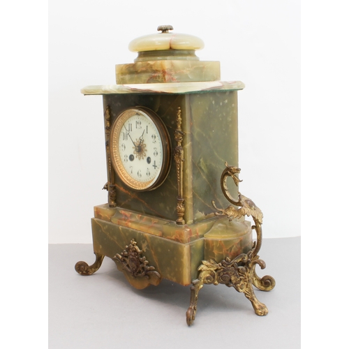 125 - A late 19th century gilt-metal-mounted and onyx-cased eight-day mantle clock: the white enamel dial ... 