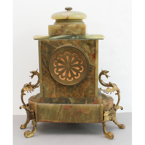 125 - A late 19th century gilt-metal-mounted and onyx-cased eight-day mantle clock: the white enamel dial ... 