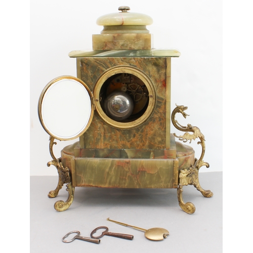 125 - A late 19th century gilt-metal-mounted and onyx-cased eight-day mantle clock: the white enamel dial ... 