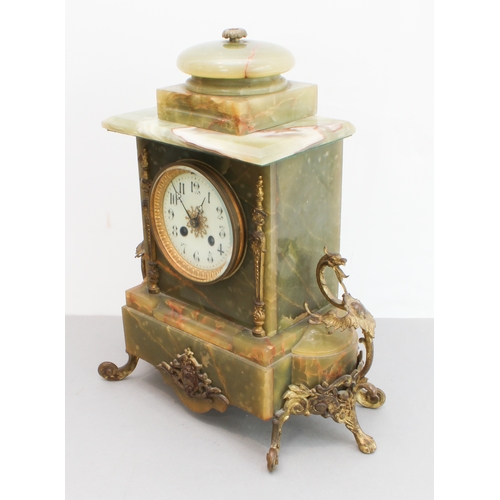 125 - A late 19th century gilt-metal-mounted and onyx-cased eight-day mantle clock: the white enamel dial ... 
