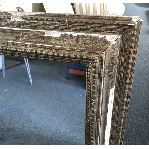 292A - A large Continental gilt and composition mirror, second quarter 20th century, the rectangular plate ... 