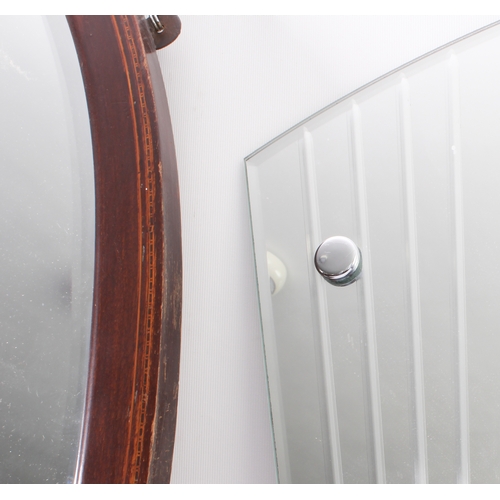 289 - Two mirrors:
 1. an early 20th century oval mahogany and boxwood-strung wall-hanging looking glass h... 