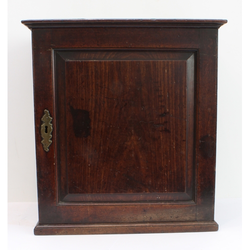 120 - A mid-18th century 'red walnut' tabletop cabinet: moulded slightly overhanging top; hinged door with... 