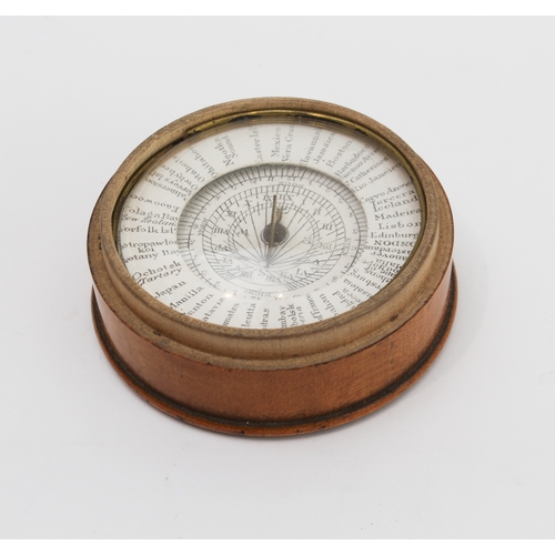 127 - An early 19th century pocket sun-dial and compass set in a turned sycamore case: the central raised ... 