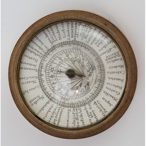 127 - An early 19th century pocket sun-dial and compass set in a turned sycamore case: the central raised ... 