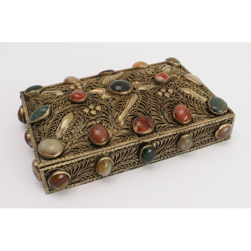 139 - A white metal gilded box with overall filigree decoration and set with numerous cabochon stones, pro... 