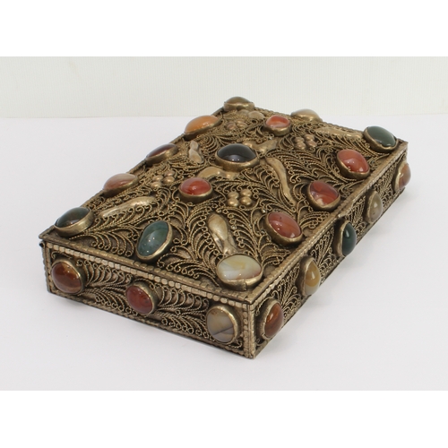 139 - A white metal gilded box with overall filigree decoration and set with numerous cabochon stones, pro... 