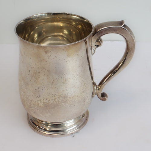 145 - A heavy hallmarked silver tankard: baluster form, spreading circular foot and maker's mark of Adie B... 