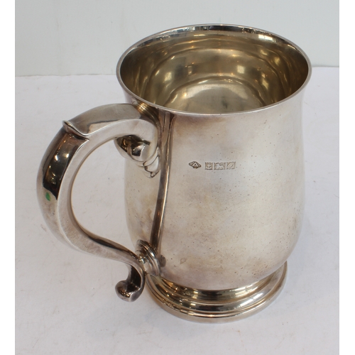 145 - A heavy hallmarked silver tankard: baluster form, spreading circular foot and maker's mark of Adie B... 