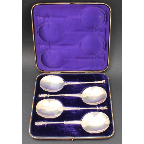 157 - A cased set of four hallmarked silver serving spoons; each with engraved scrollwork-style decoration... 