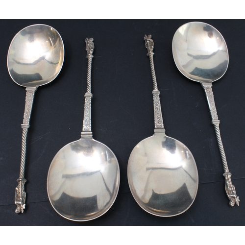 157 - A cased set of four hallmarked silver serving spoons; each with engraved scrollwork-style decoration... 