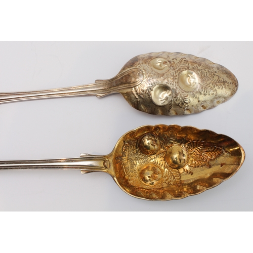 200 - A set of four mid-19th century silver berry spoons: fiddle and thread pattern with chased floral ter... 