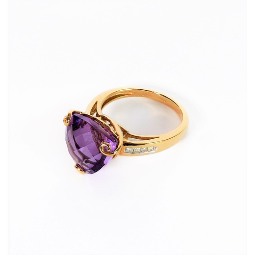 211 - A 9-carat yellow gold dress ring: centrally set with a trillion-cut amethyst of good colour, unusual... 