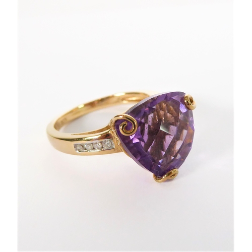 211 - A 9-carat yellow gold dress ring: centrally set with a trillion-cut amethyst of good colour, unusual... 