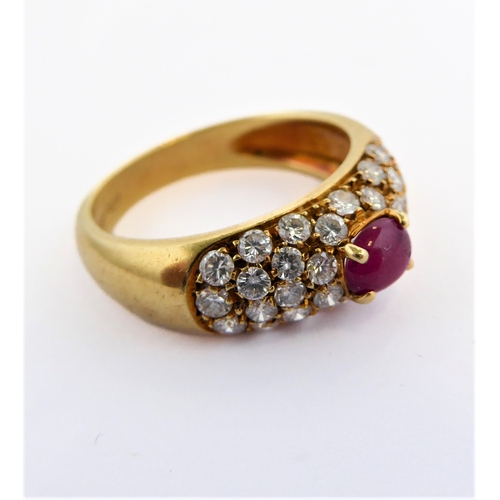 219 - A lady's 18-carat yellow gold (marked 750) dress ring centrally set with a horizontal ruby polished ... 