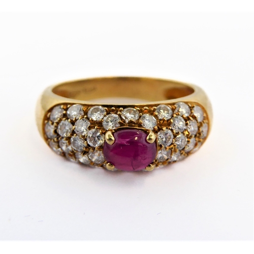 219 - A lady's 18-carat yellow gold (marked 750) dress ring centrally set with a horizontal ruby polished ... 