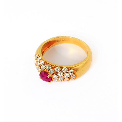 219 - A lady's 18-carat yellow gold (marked 750) dress ring centrally set with a horizontal ruby polished ... 