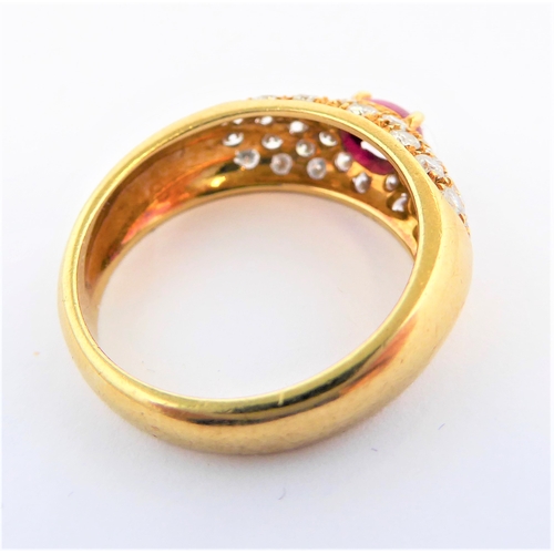 219 - A lady's 18-carat yellow gold (marked 750) dress ring centrally set with a horizontal ruby polished ... 