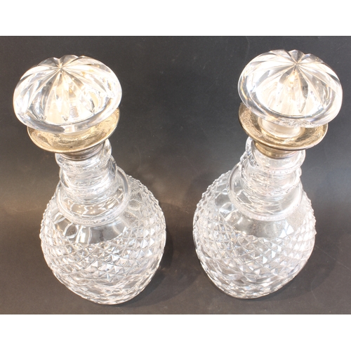 25 - A pair of modern cut-glass mallet-shaped decanters with mushroom stoppers and silver-mounted necks (... 