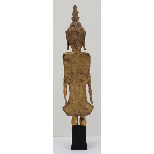 43 - A giltwood figure of Buddha: Laos / Lanna, probably early 20th century, the standing figure with lon... 