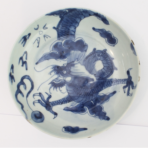 51 - Ming Dynasty (1368-1644) - a Chinese porcelain dragon dish: four-clawed dragon in underglaze blue fl... 