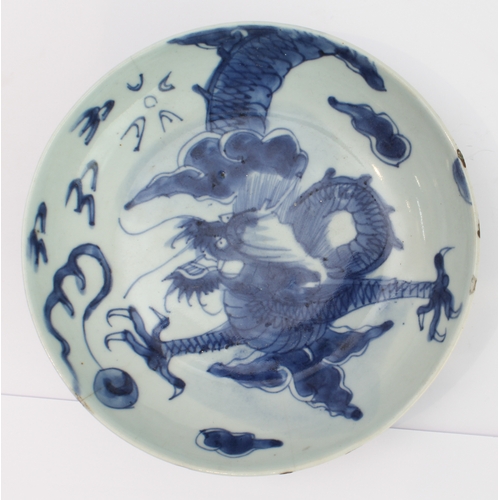 51 - Ming Dynasty (1368-1644) - a Chinese porcelain dragon dish: four-clawed dragon in underglaze blue fl... 