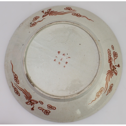 67 - A large Japanese earthenware Kutani dish
 Meiji period (1868-1912), finely painted with a feasting s... 