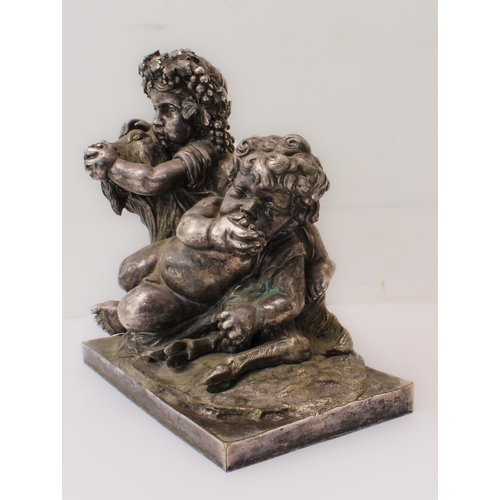 84 - A silvered bronze Bacchanalian figural group: 20th century, depicting two Bacchanalian putti with a ... 