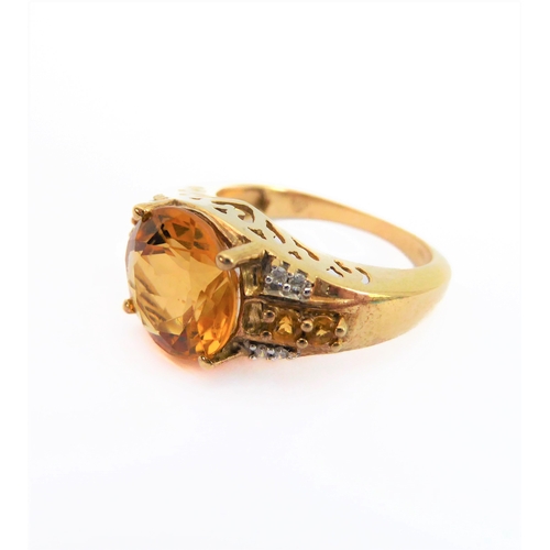 232 - A 9-carat yellow gold dress ring: centrally set with a good sized hand-cut citrine flanked by two di... 