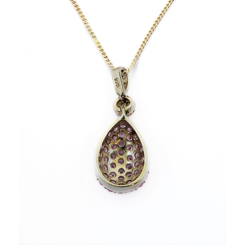 245 - A pear-shaped silver pendant set with a multitude of small hand-cut pink stones; the suspension loop... 