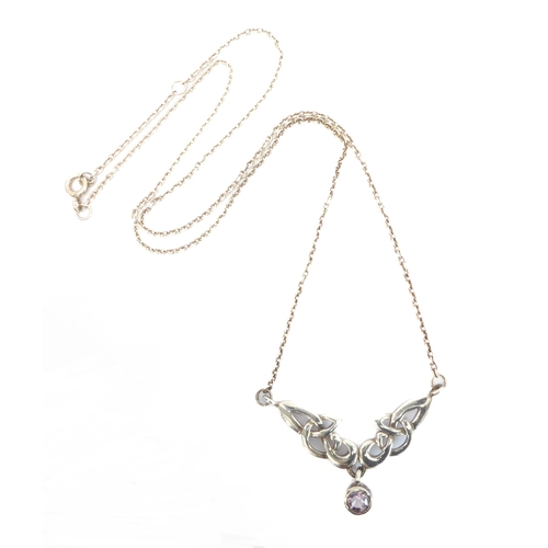 247 - A silver necklace pierced in Celtic style and with a single hand-cut circular amethyst-style dropper... 