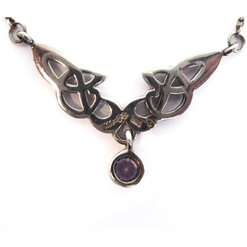 247 - A silver necklace pierced in Celtic style and with a single hand-cut circular amethyst-style dropper... 