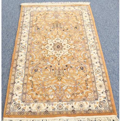 594 - A Kashmir rug; light terracotta ground with ivory central medallion and main ivory border (156 x 93 ... 