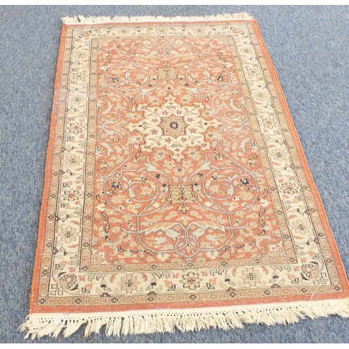 594 - A Kashmir rug; light terracotta ground with ivory central medallion and main ivory border (156 x 93 ... 