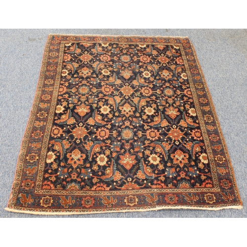 595 - A circa 1900 north-west Persian Feraghan rug; dark-blue field with Herati design in blue and red wit... 