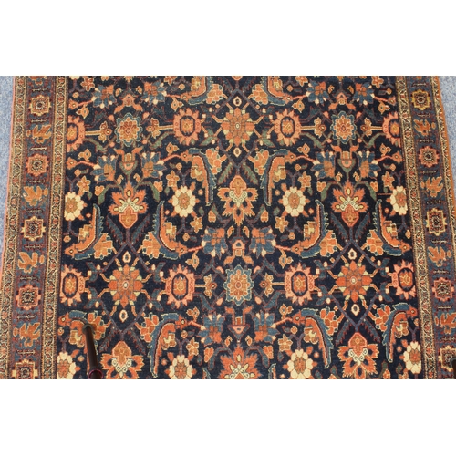 595 - A circa 1900 north-west Persian Feraghan rug; dark-blue field with Herati design in blue and red wit... 