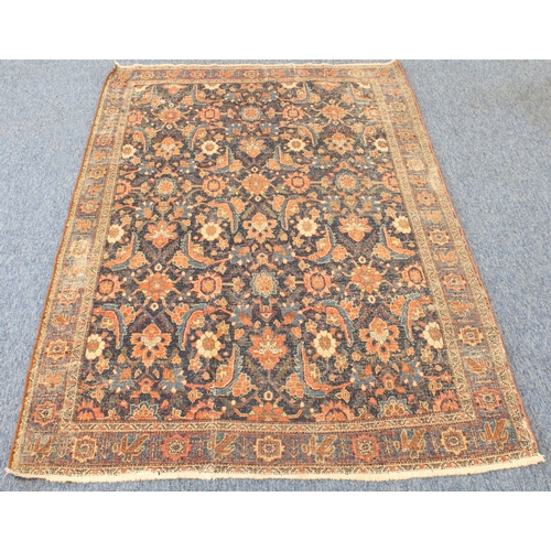 595 - A circa 1900 north-west Persian Feraghan rug; dark-blue field with Herati design in blue and red wit... 